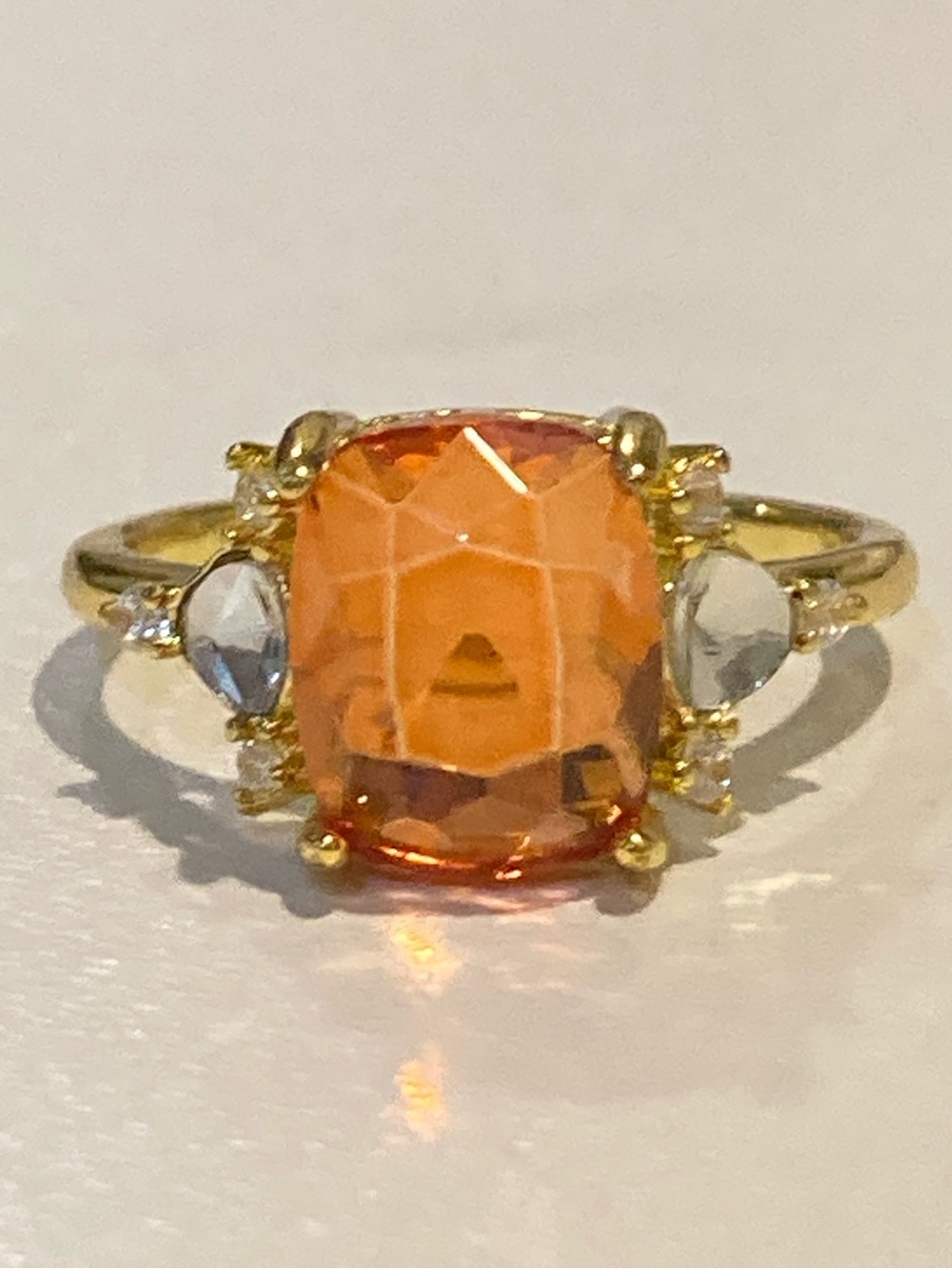 Gold Ring with Orange Cushion-Cut Center Stone and Clear Side Stones